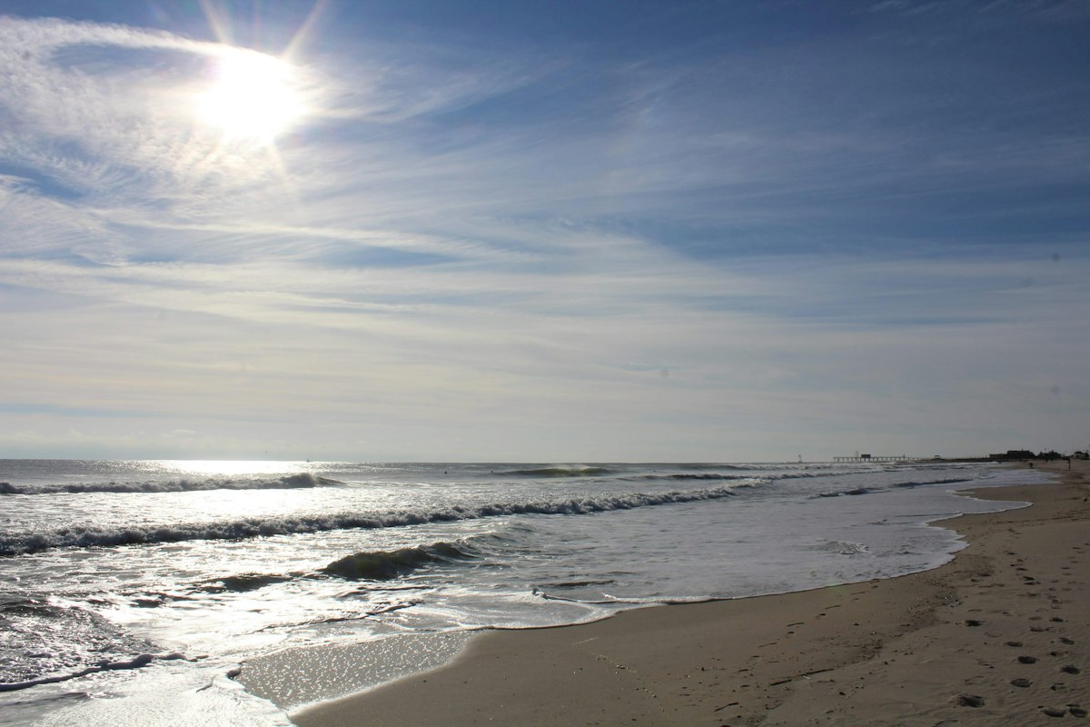 Sun shining over the ocean and beach