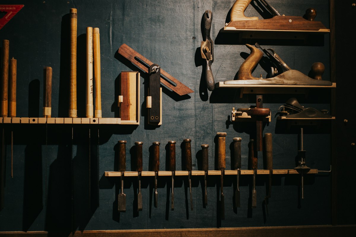 Hand tools arranged on a workshop wall